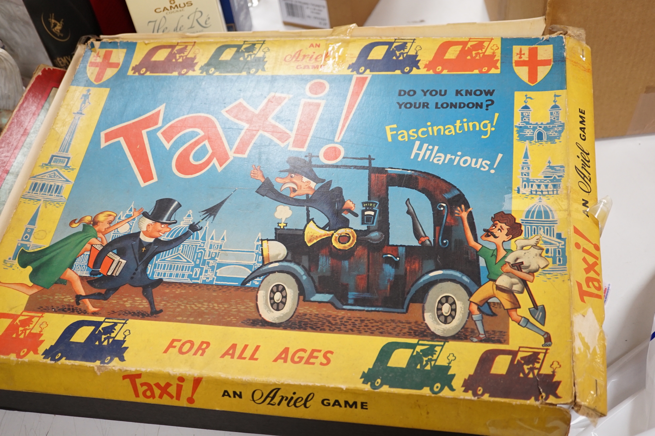 A collection of tinplate toys including cars, a fire engine, a Firebird jet plane, a Tri-ang lifeboat, an Tri-ang Minic tractor, etc. (11), together with a box of boardgames including Vintage Gibson and others; Bandit Ch